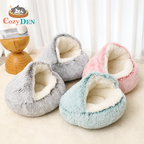 Three plush pet beds in gray, pink, and blue on a light surface with 'Cozy Den' branding.