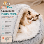 A sleeping long-haired cat curled up inside a fluffy gray and white Cozy Den hideaway bed, with promotional text and icons on a warm beige background.
