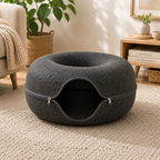 Gray pet bed with a zipper on a beige carpet in a cozy living room.