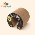 Halloween-themed cardboard tube with decorative elements on a beige background, featuring the Cozy Kurl brand.