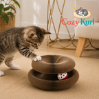 Kitten playing with a Cozy Kurl product on a carpeted floor.