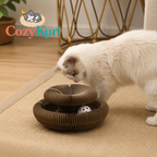 Cat playing with a cardboard cat toy on a carpeted floor, with 'CozyKurl' branding.